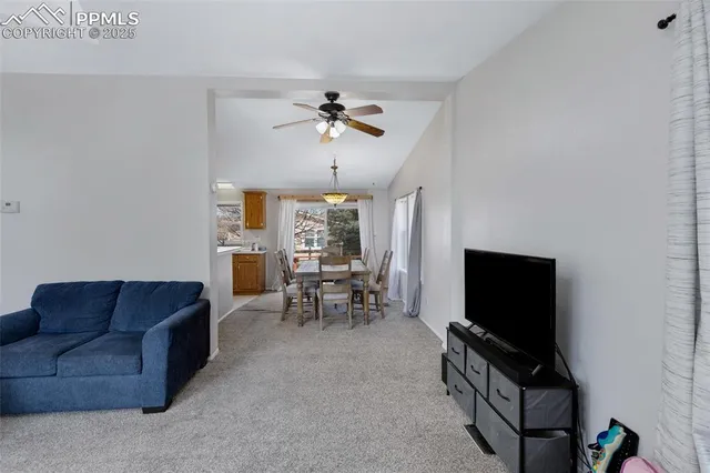 a living room with furniture a flat screen tv and a window