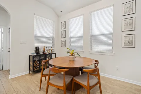 a dining room with furniture and window