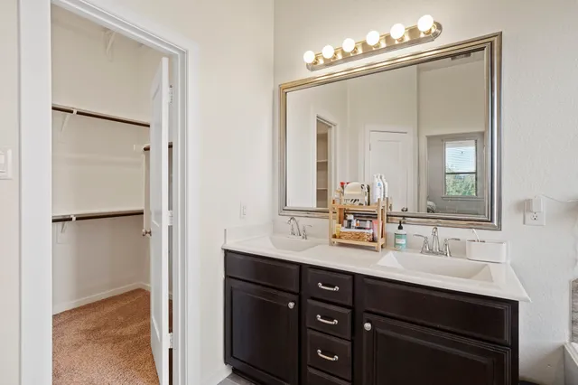 a bathroom with a sink vanity and a mirror