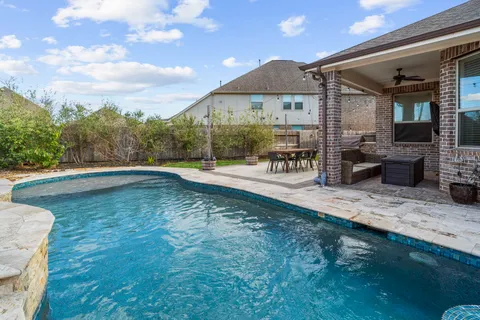 a view of a patio with table and chairs with wooden floor and fence