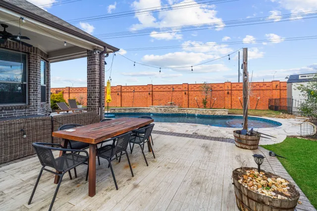 a backyard of a house with table and chairs