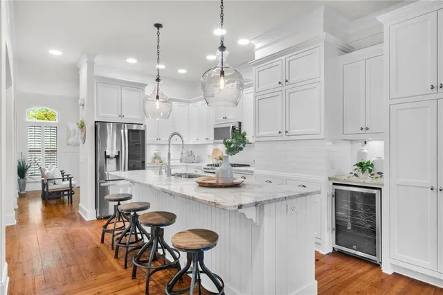 a kitchen with kitchen island granite countertop a table and chairs in it