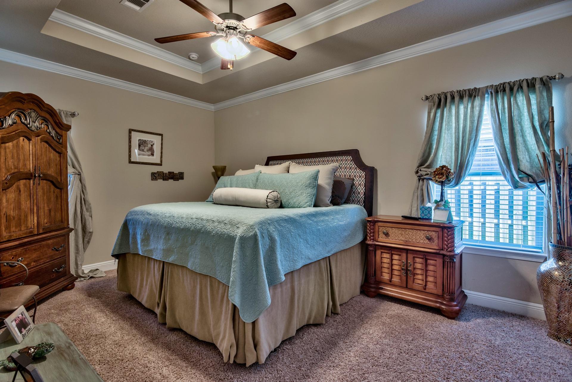 56 Pin Oak Loop Santa Rosa Beach, FL 32459 - Photo 13 of 27 a bedroom with a bed window and a chandelier