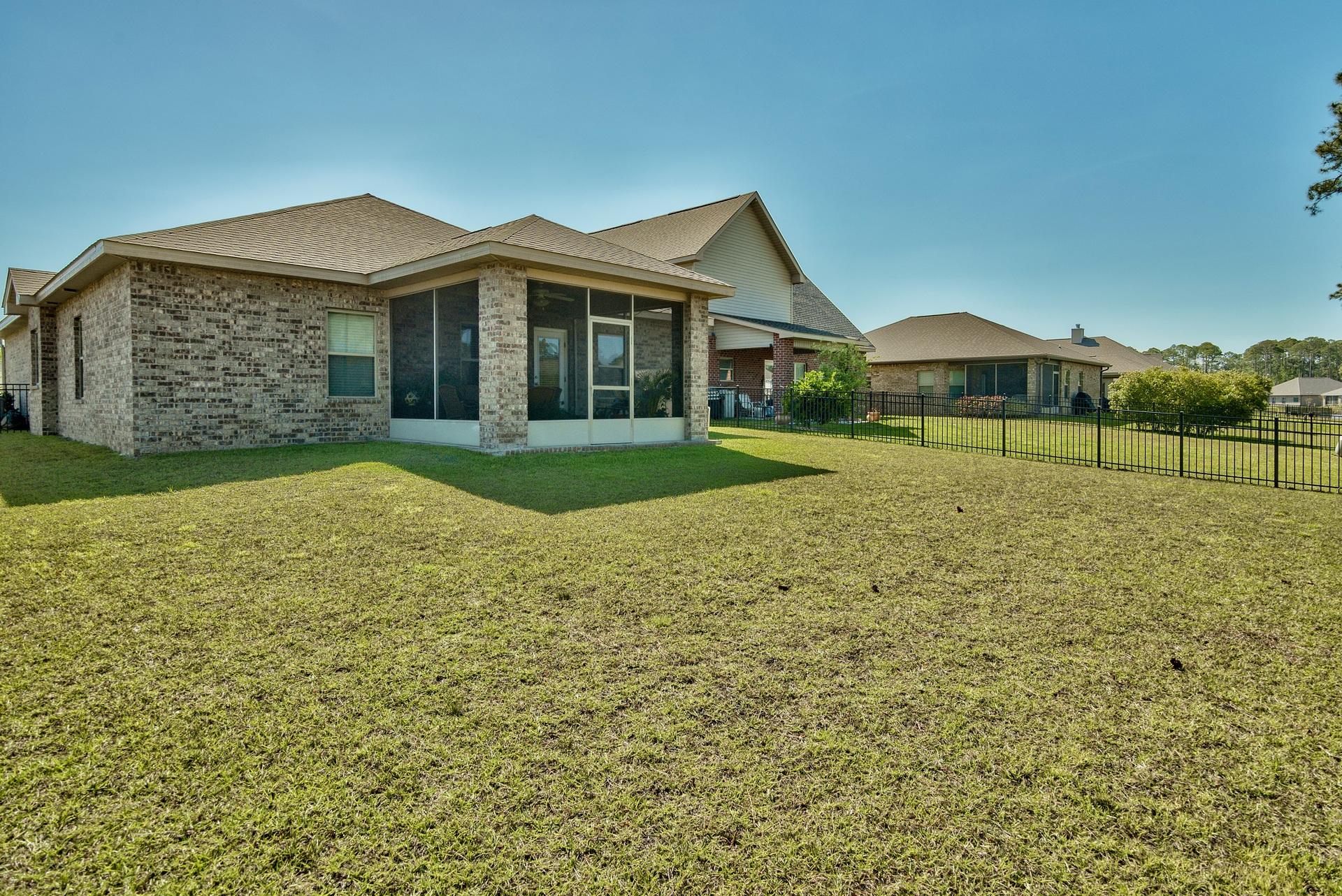 56 Pin Oak Loop Santa Rosa Beach, FL 32459 - Photo 25 of 27 a view of a big house with a big yard and large trees