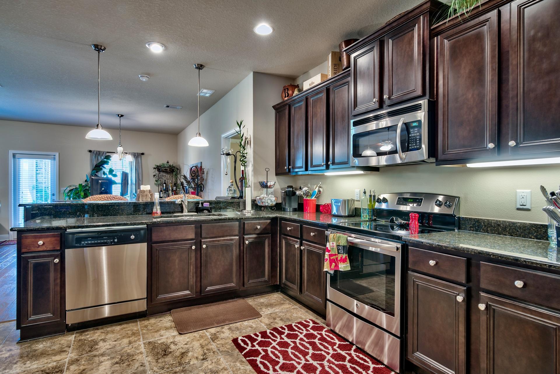 56 Pin Oak Loop Santa Rosa Beach, FL 32459 - Photo 6 of 27 a kitchen with stainless steel appliances granite countertop a sink stove and cabinets