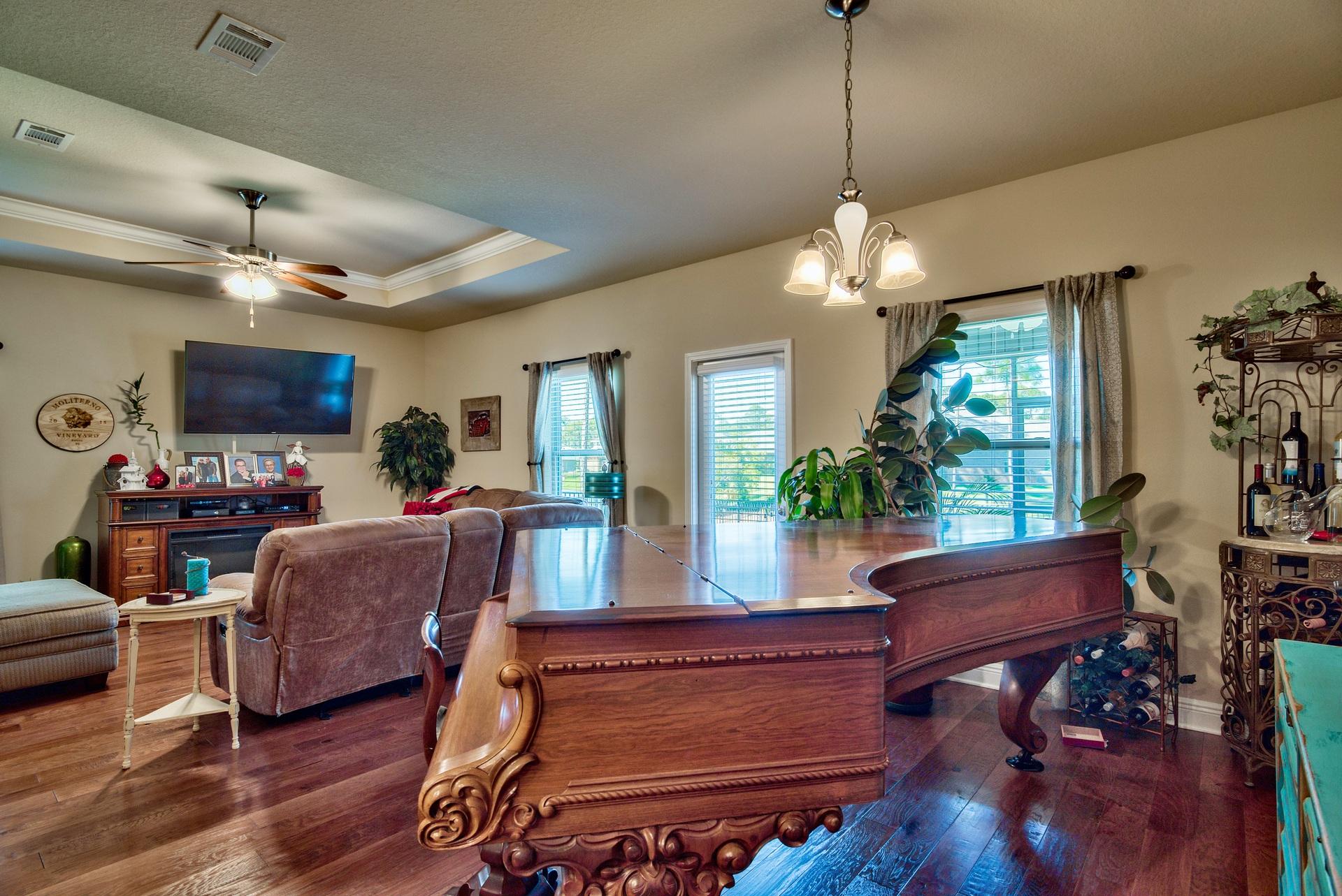 56 Pin Oak Loop Santa Rosa Beach, FL 32459 - Photo 10 of 27 a living room with furniture a window and a chandelier