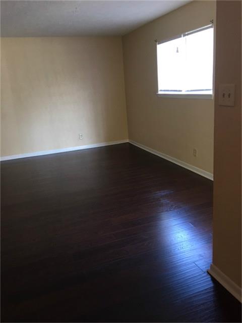 275 North 7th Street, Unit 5 Beaumont, TX 77702 - Photo 3 of 9 a view of room with wooden floor and windows