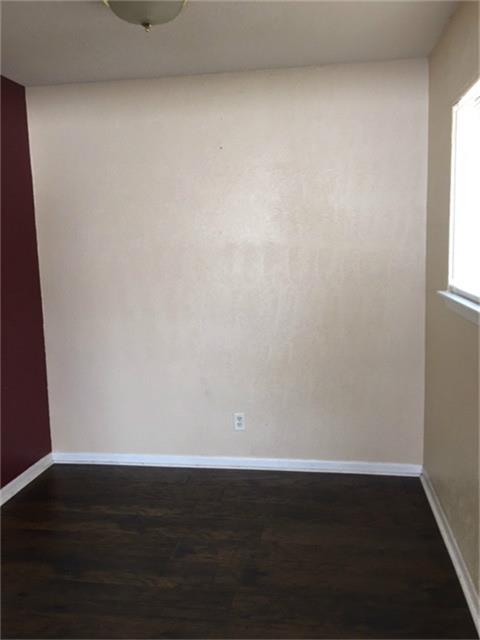 275 North 7th Street, Unit 5 Beaumont, TX 77702 - Photo 6 of 9 a view of an empty room with wooden floor and a window