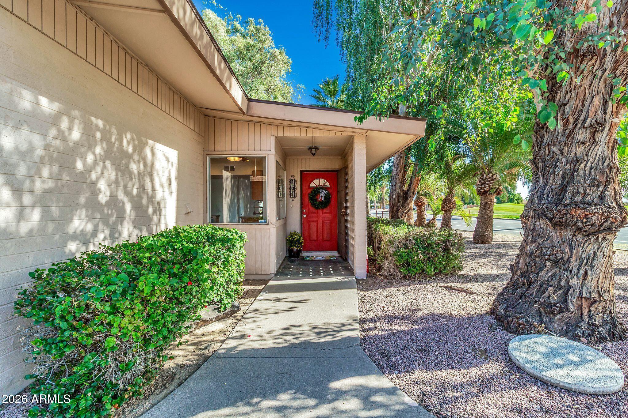 725 South Power Road, Unit 101 Mesa, AZ 85206 - Photo 12 of 38 a front view of a house with garden