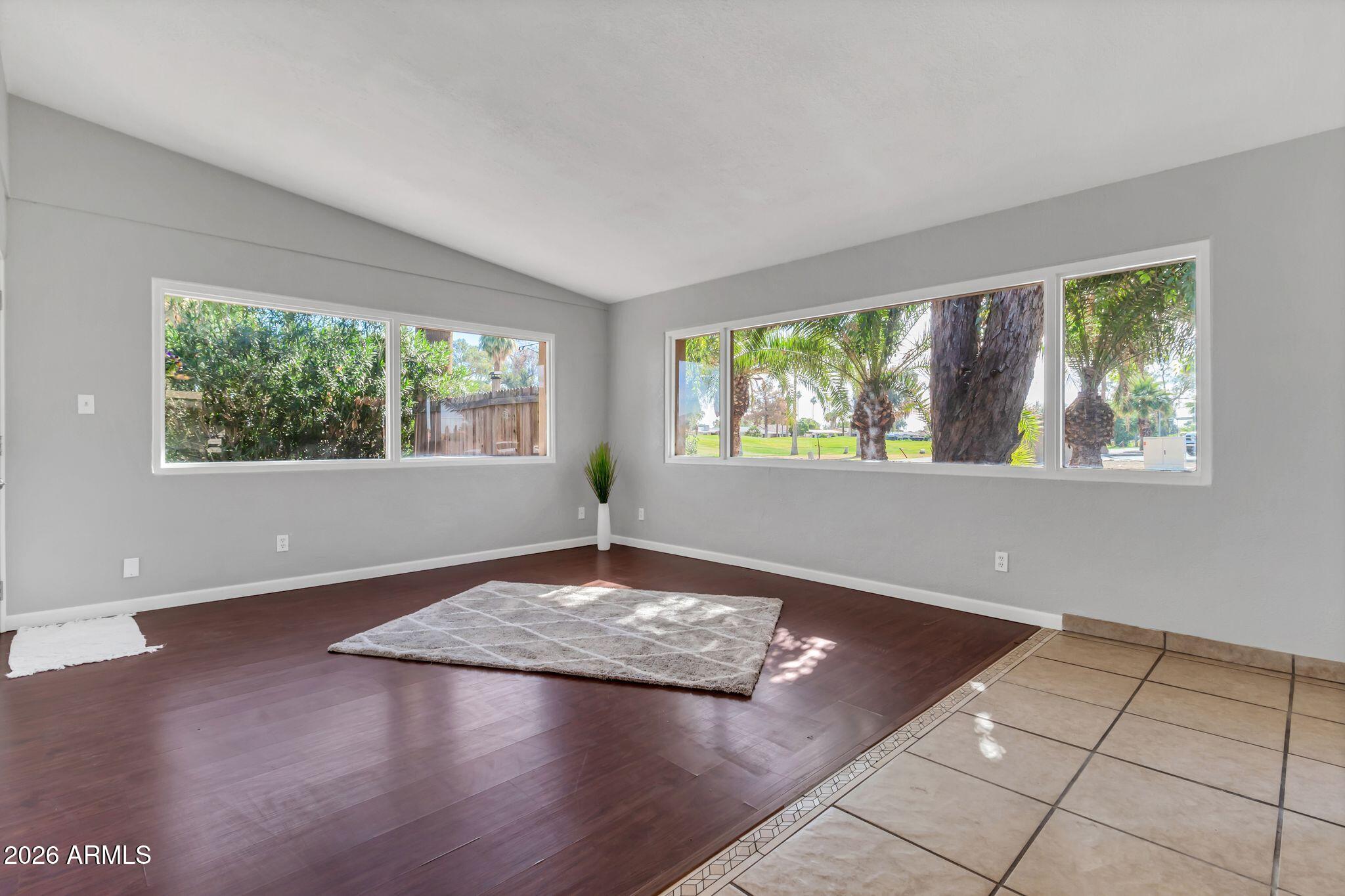 725 South Power Road, Unit 101 Mesa, AZ 85206 - Photo 15 of 38 a view of an empty room with wooden floor and a window