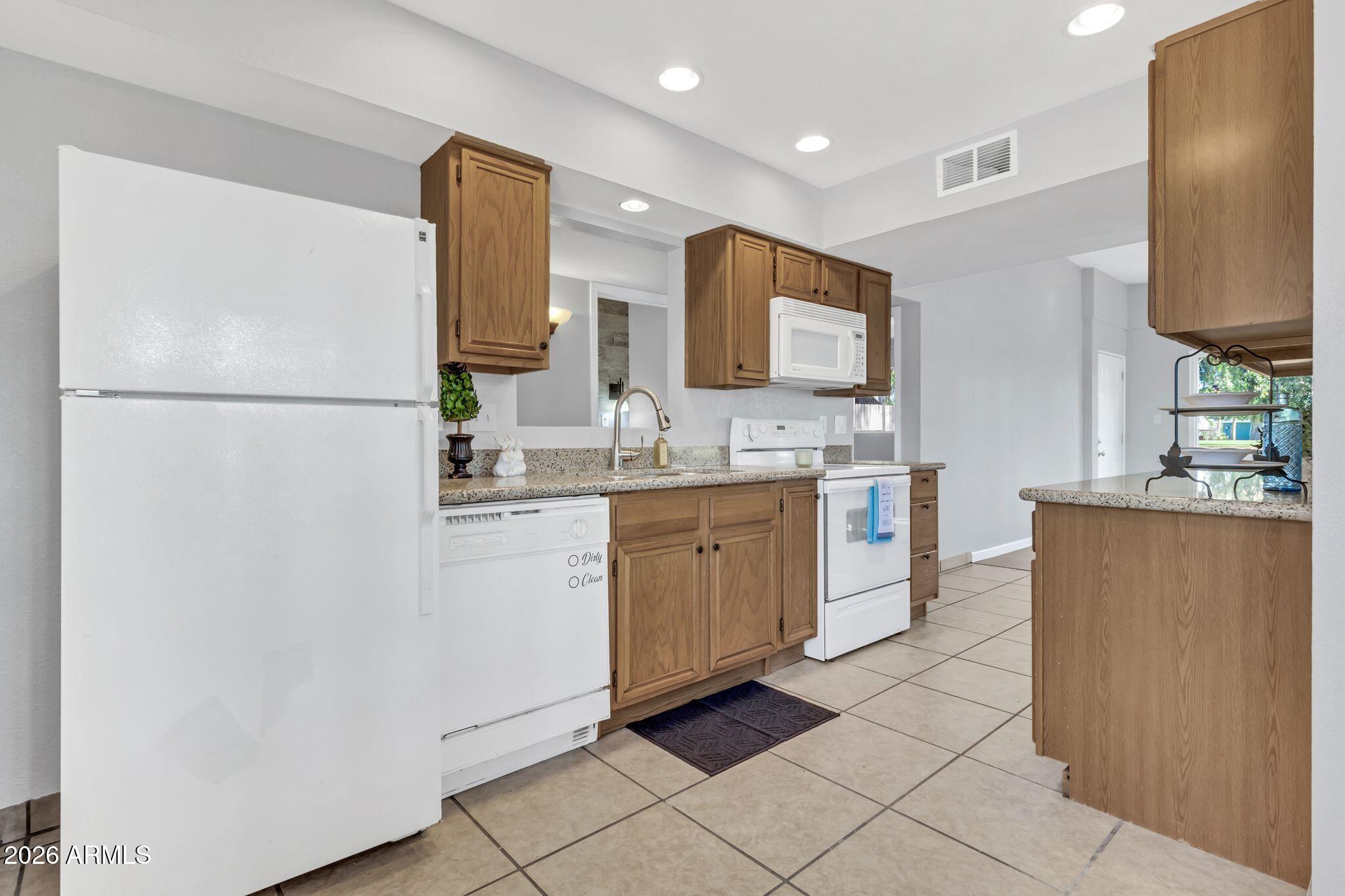 725 South Power Road, Unit 101 Mesa, AZ 85206 - Photo 18 of 38 a kitchen with a refrigerator sink and microwave