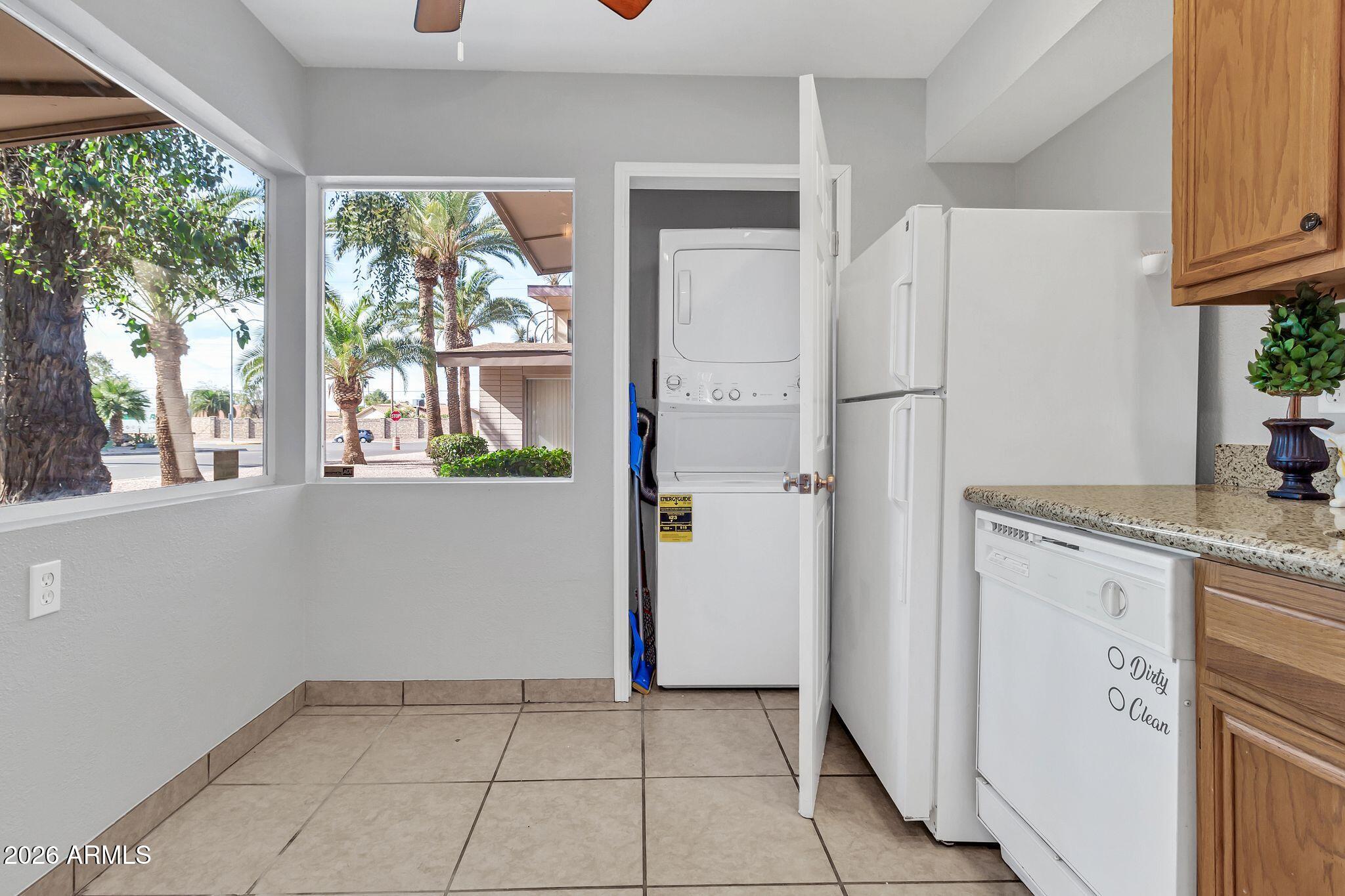 725 South Power Road, Unit 101 Mesa, AZ 85206 - Photo 20 of 38 a kitchen with white cabinets and refrigerator