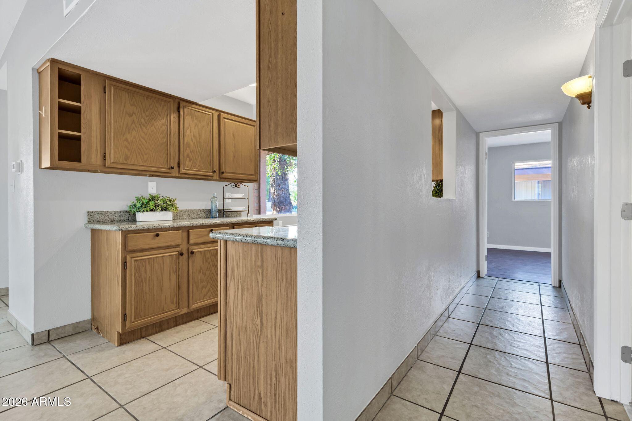 725 South Power Road, Unit 101 Mesa, AZ 85206 - Photo 22 of 38 a kitchen with cabinets and window