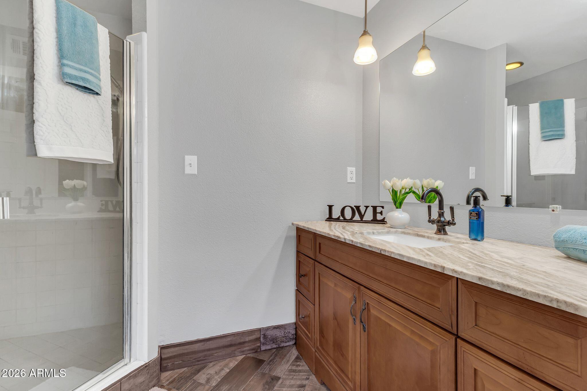 725 South Power Road, Unit 101 Mesa, AZ 85206 - Photo 25 of 38 a bathroom with a sink and a mirror