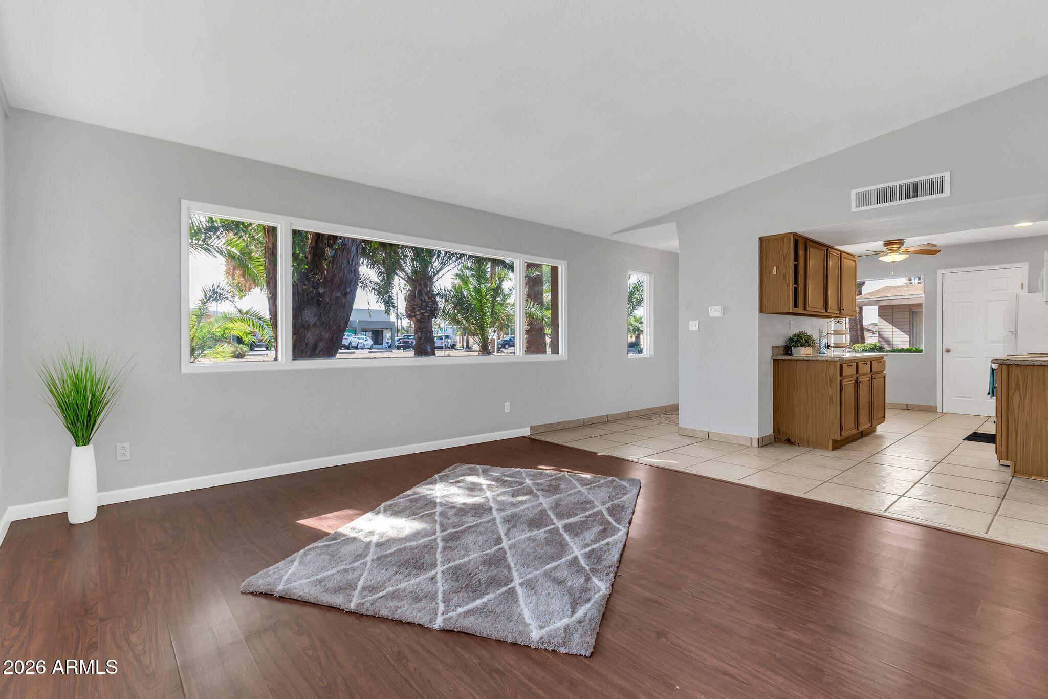 725 South Power Road, Unit 101 Mesa, AZ 85206 - Photo 2 of 38 a living room with furniture and a wooden floor