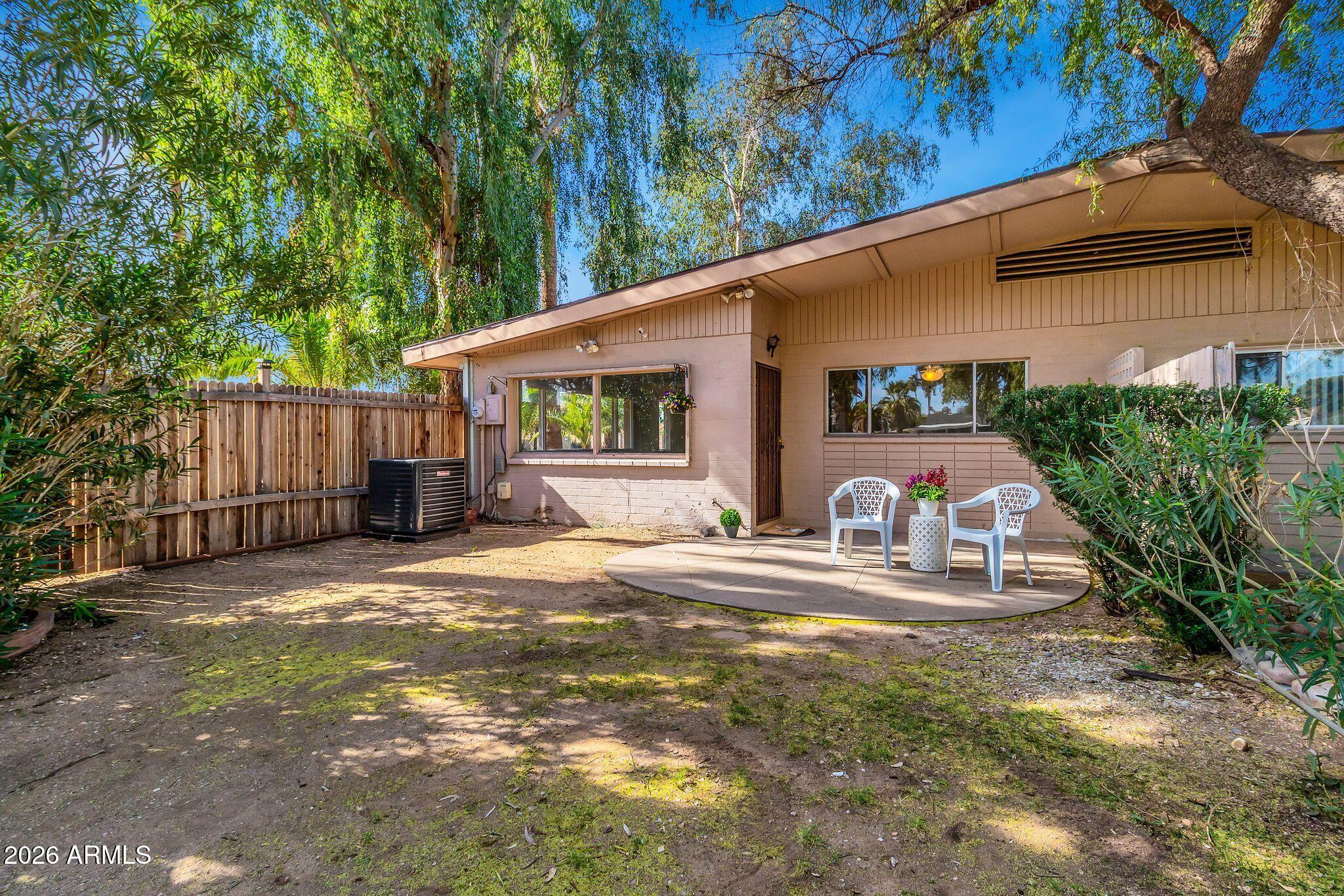 725 South Power Road, Unit 101 Mesa, AZ 85206 - Photo 31 of 38 a view of a house with backyard and sitting area