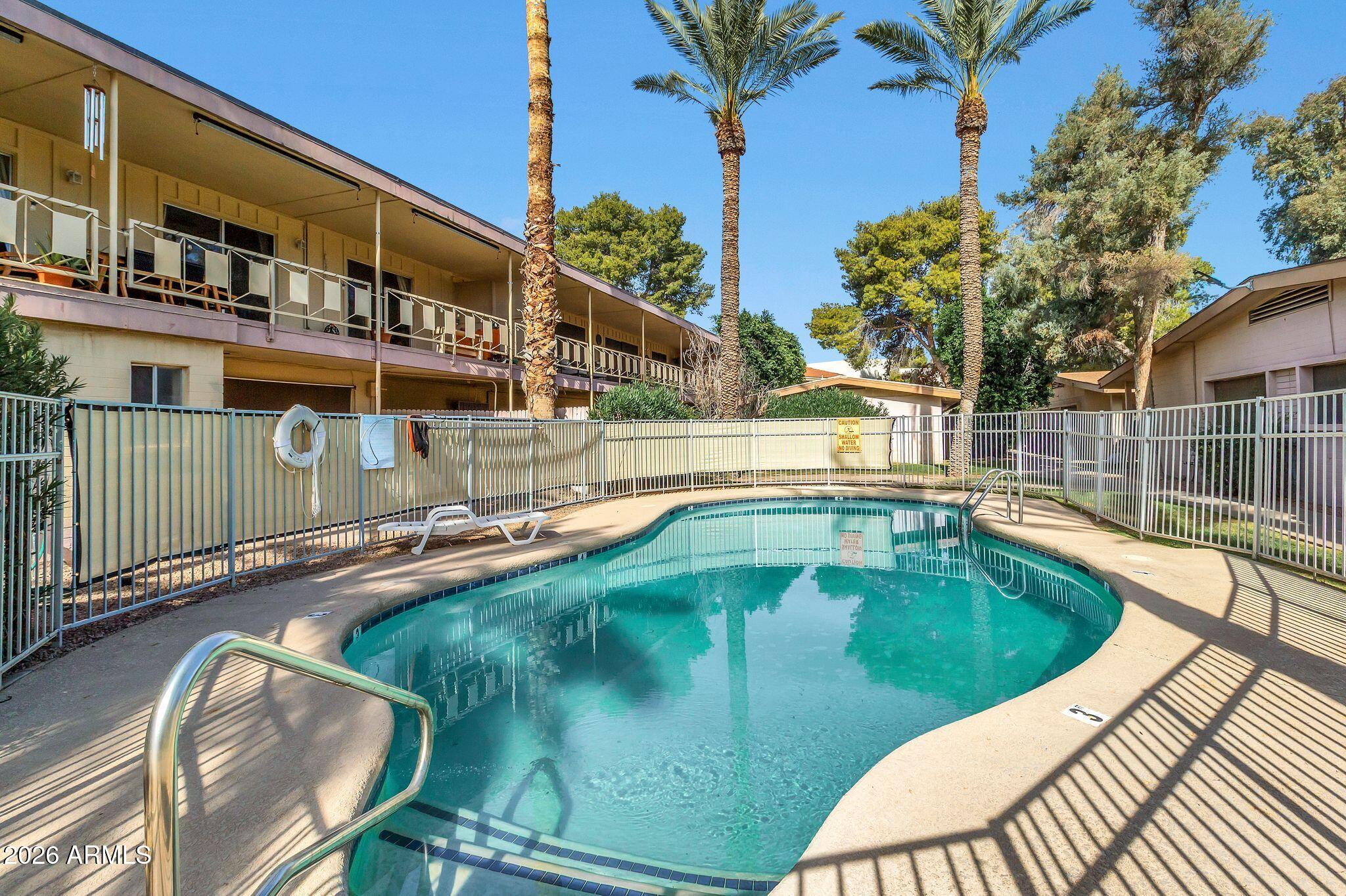 725 South Power Road, Unit 101 Mesa, AZ 85206 - Photo 33 of 38 a view of a swimming pool with a patio