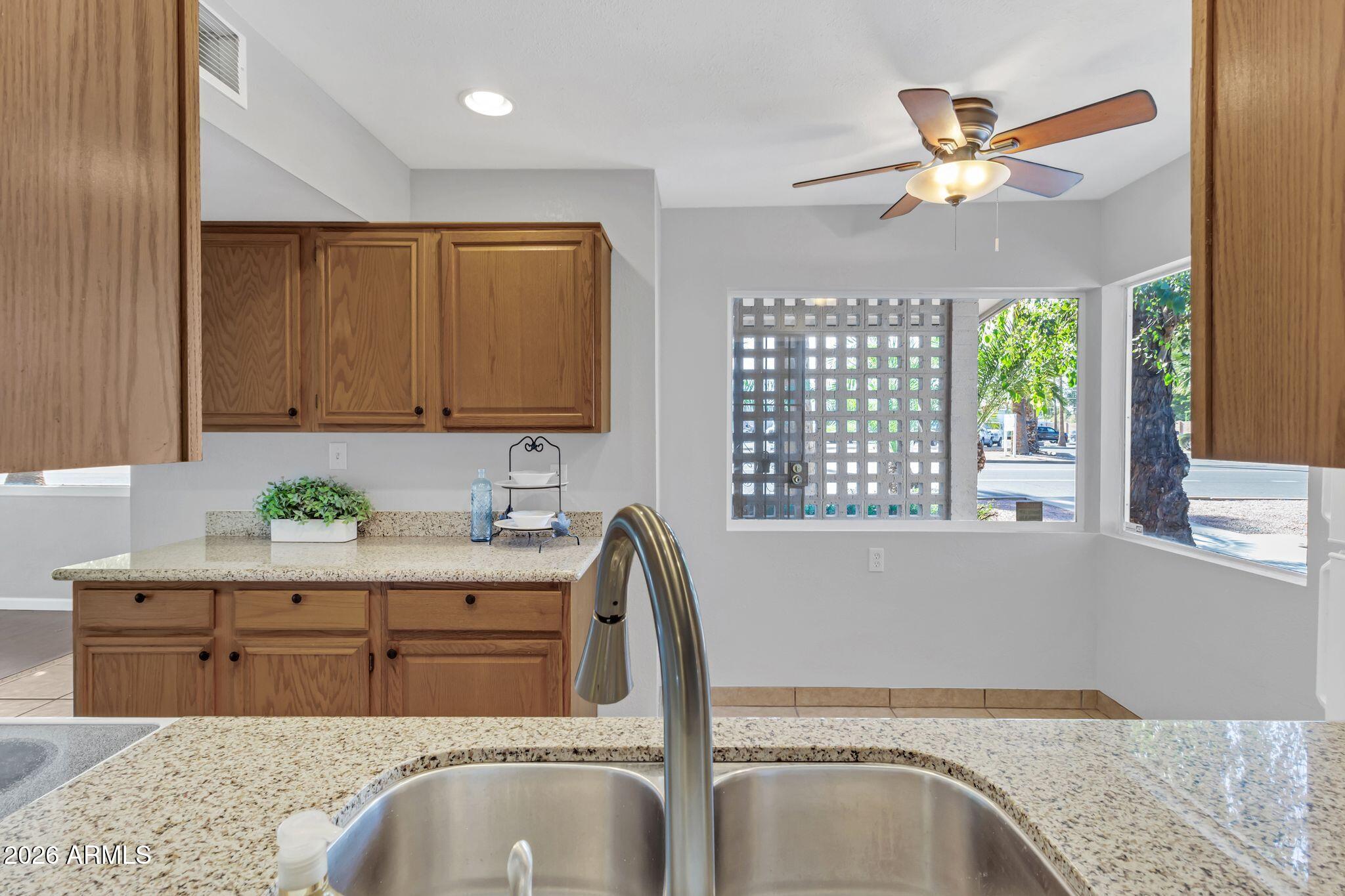 725 South Power Road, Unit 101 Mesa, AZ 85206 - Photo 7 of 38 a kitchen with a cabinets a sink and a window