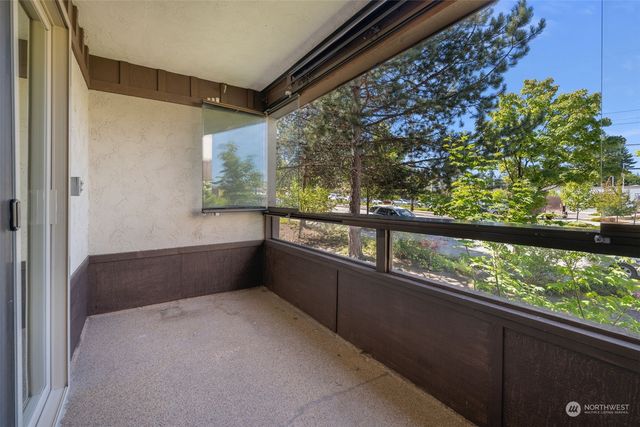 a view of two chairs in a balcony