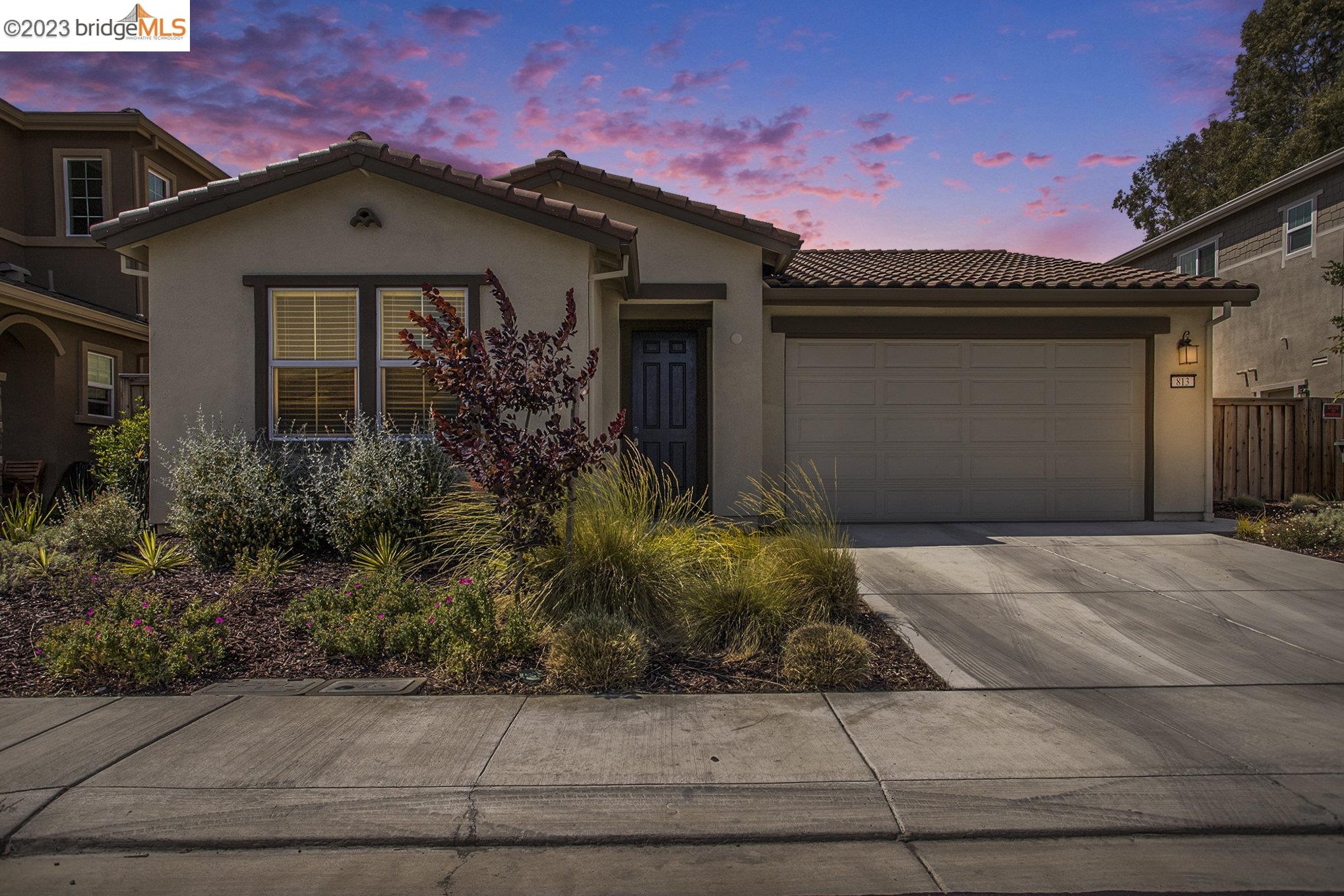 a front view of a house with garden