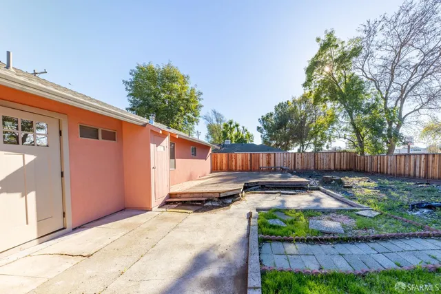 a backyard of a house with yard and outdoor seating