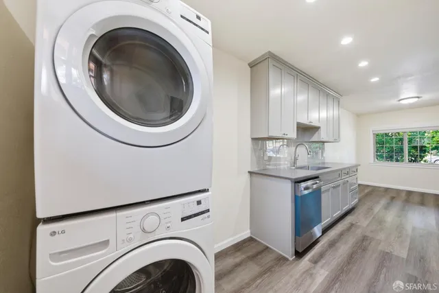 a kitchen with granite countertop a sink and a stove top oven