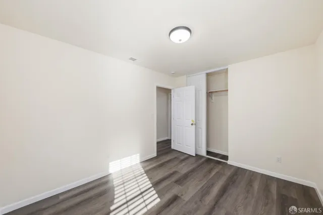 a view of a room with wooden floor