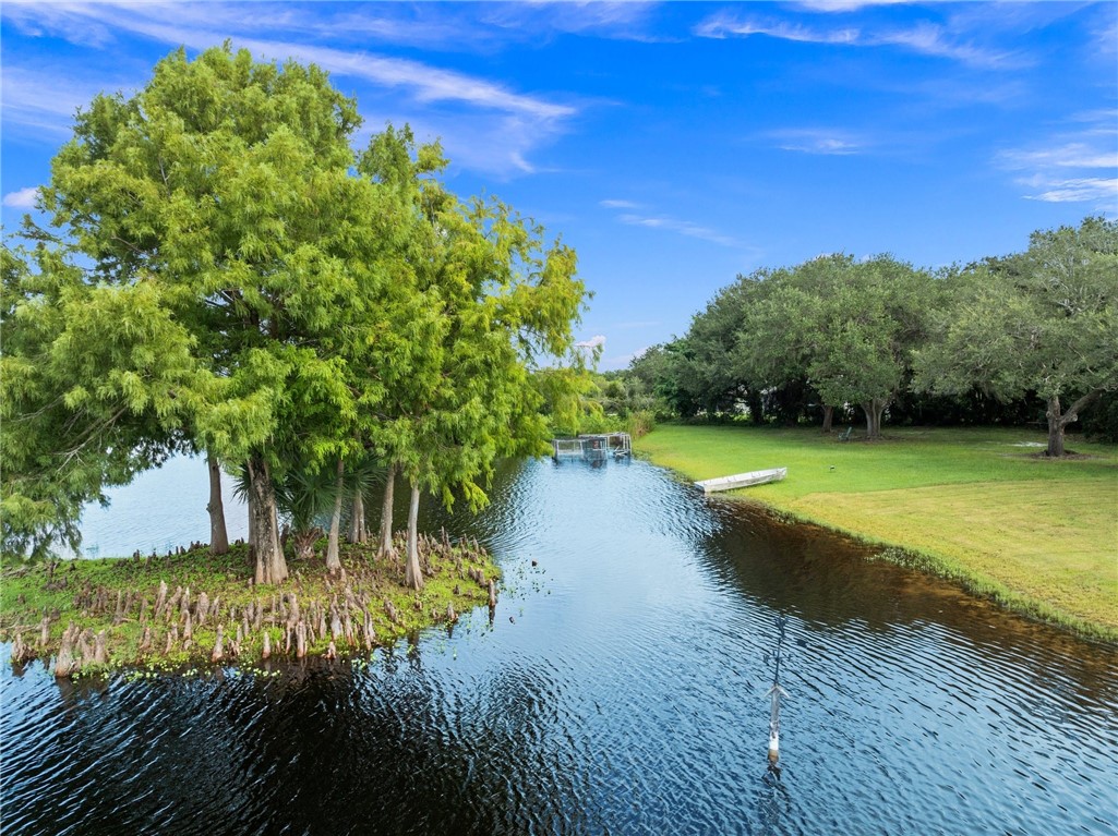 5051 Tozour Road Fort Pierce, FL 34946 - Photo 19 of 31 a view of a lake with a yard