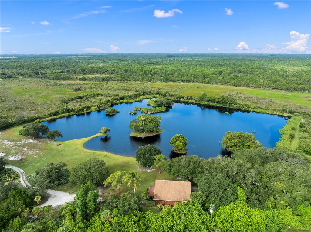 5051 Tozour Road Fort Pierce, FL 34946 - Photo 8 of 31 a view of a lake with a yard
