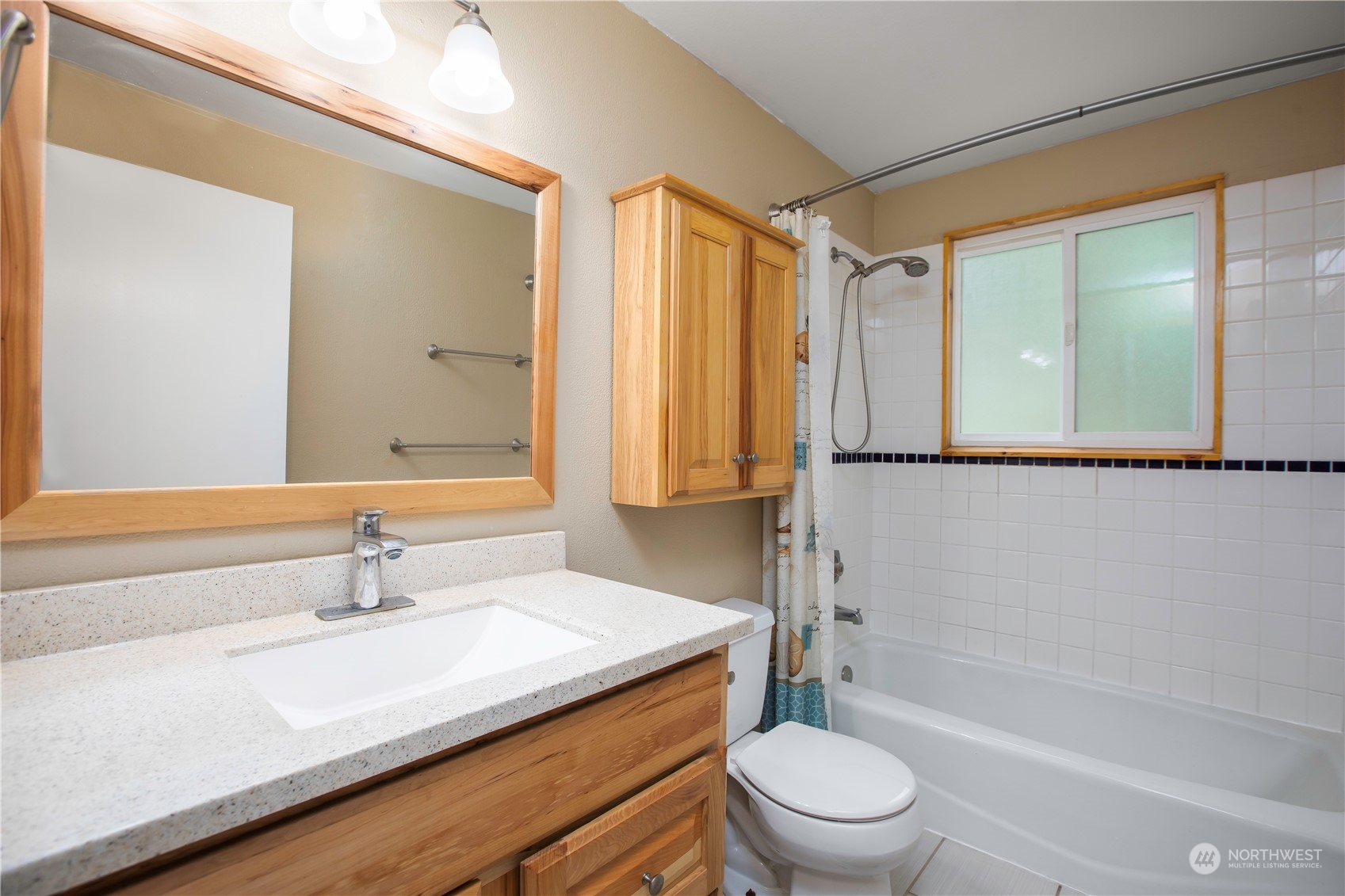 14092 Southeast 190th Street Renton, WA 98058 - Photo 19 of 27 a bathroom with a sink a toilet and a large mirror
