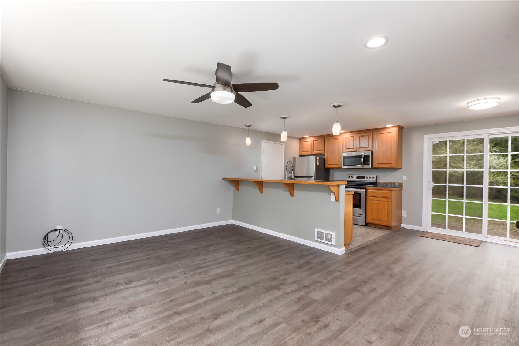 14092 Southeast 190th Street Renton, WA 98058 - Photo 7 of 27 a view of a kitchen with wooden floor and electronic appliances