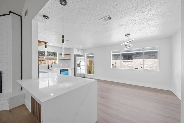 a kitchen with kitchen island a counter top space and a center island