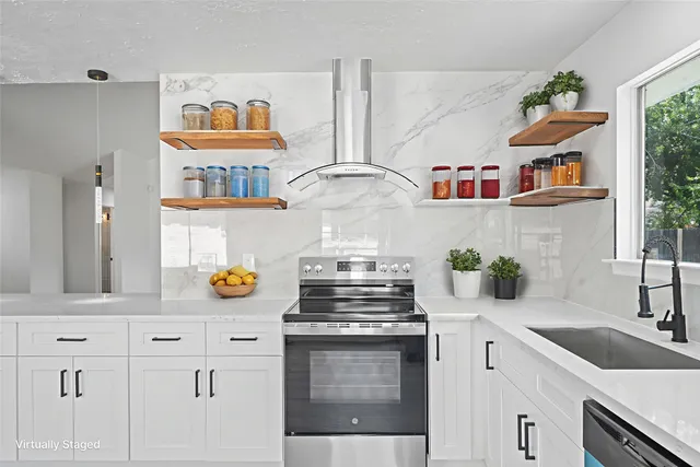 a kitchen with stainless steel appliances granite countertop a stove and a sink