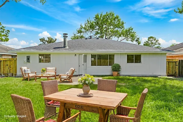 a view of a house with a backyard
