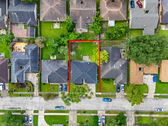 an aerial view of houses with yard