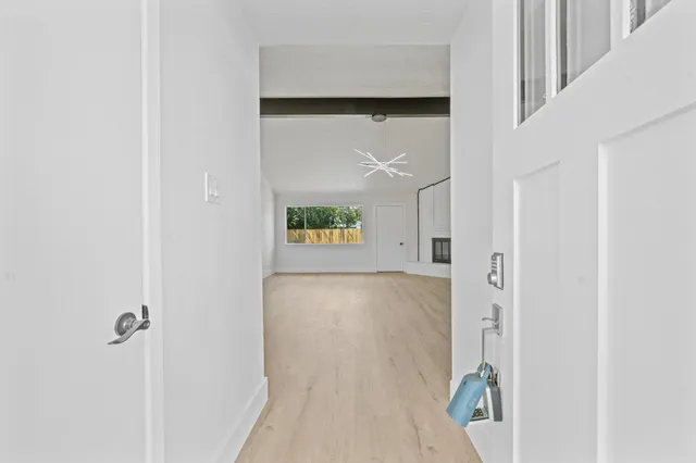 a view of a hallway to rooms