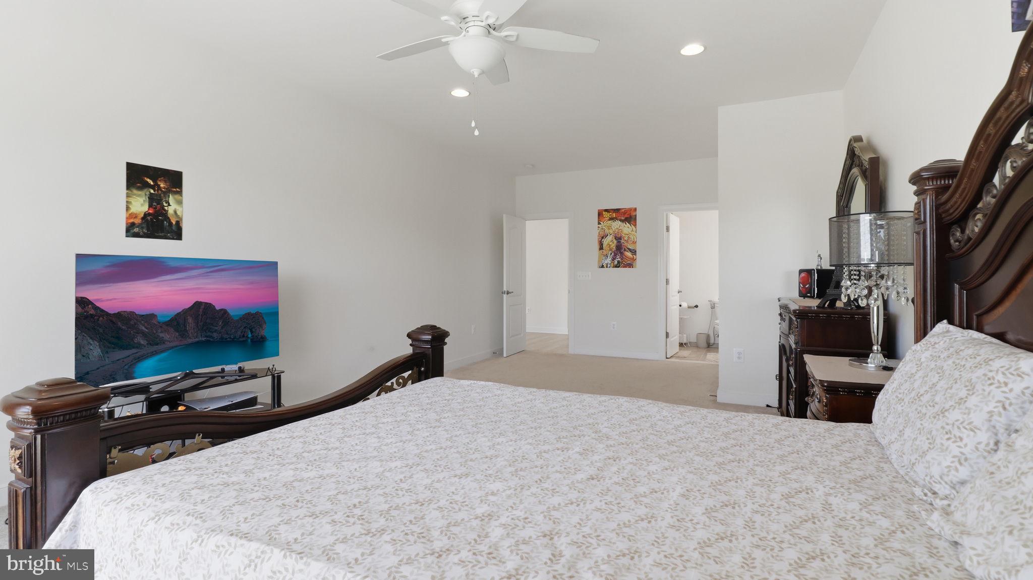 11502 Aden Road Nokesville, VA 20181 - Photo 61 of 106 a bedroom with a bed and a flat screen tv