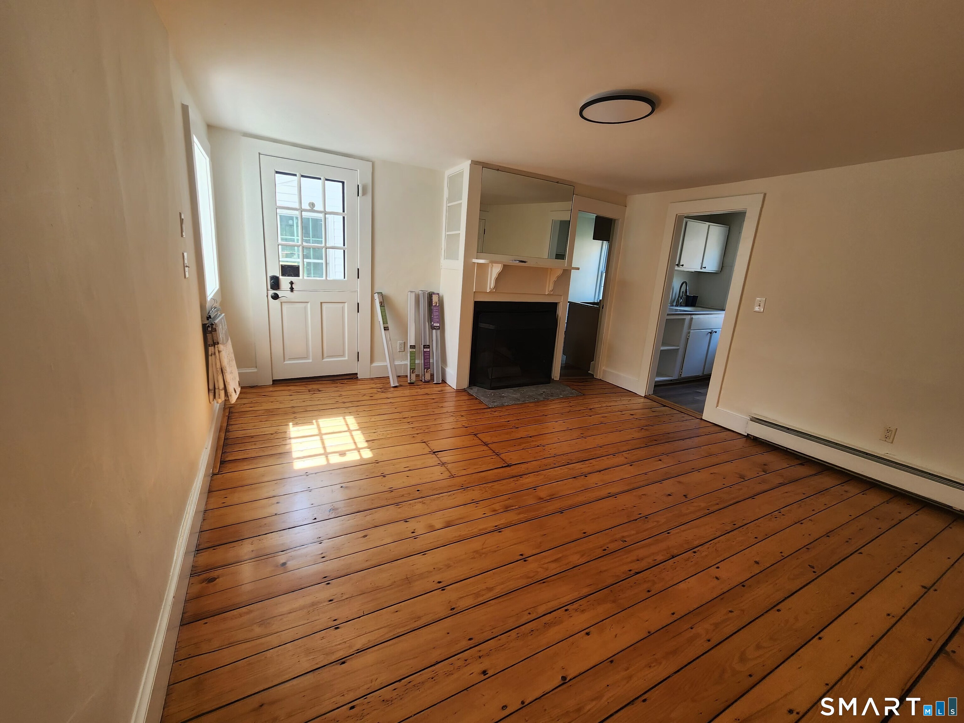82 State Street, Unit 1 Guilford, CT 06437 - Photo 2 of 9 a view of a room with wooden floor and windows