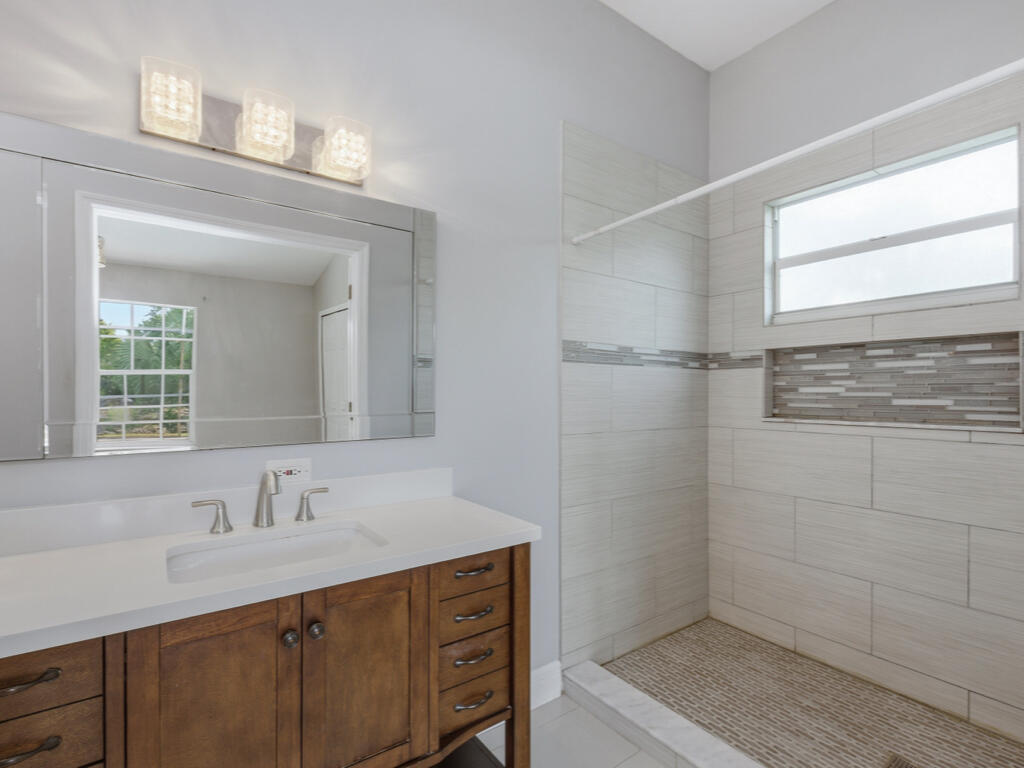 3650 Kent Drive Naples, FL 34112 - Photo 7 of 17 a bathroom with a sink and a mirror