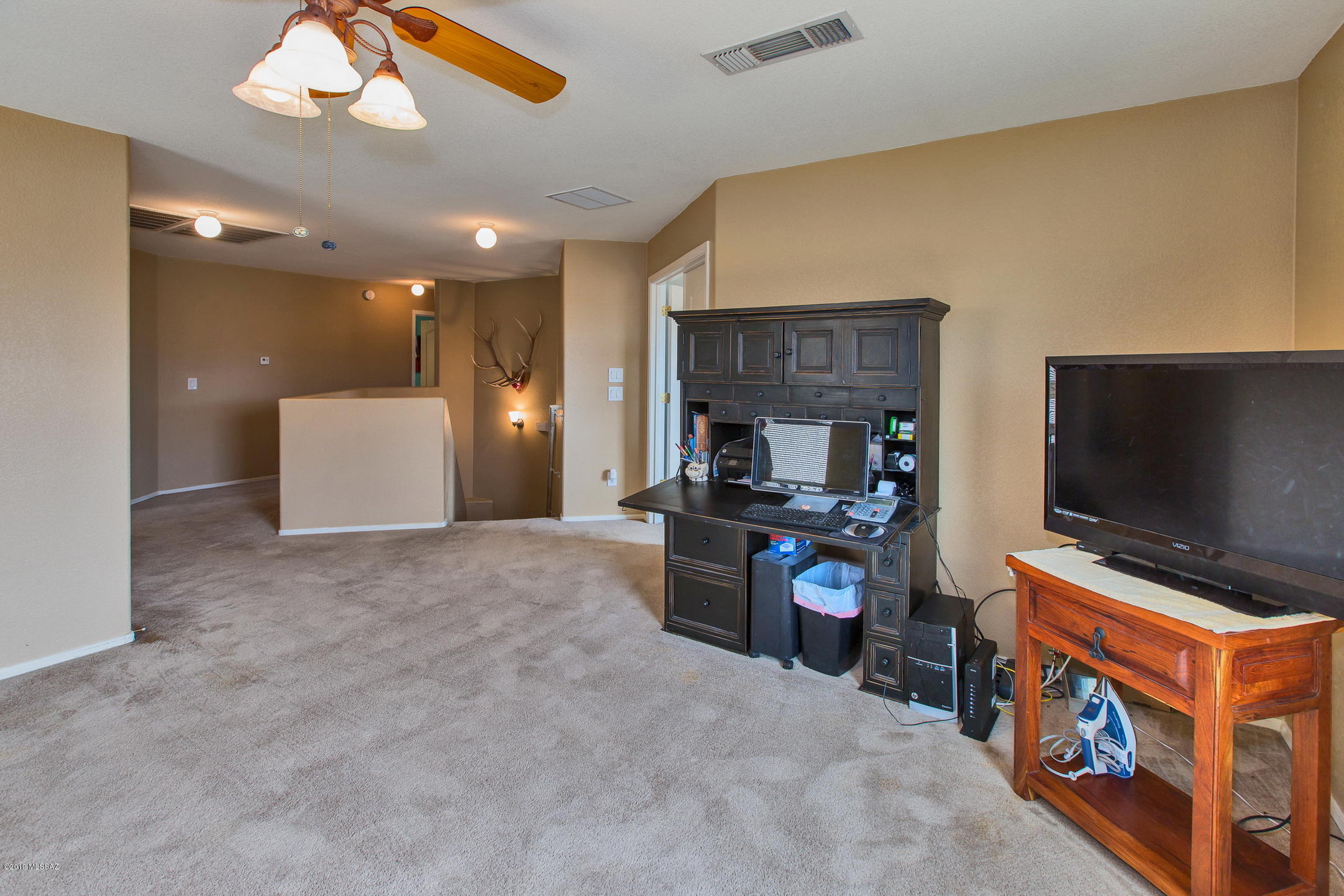 3600 East Mecate Road Tucson, AZ 85739 - Photo 25 of 39 a living room with furniture and a flat screen tv