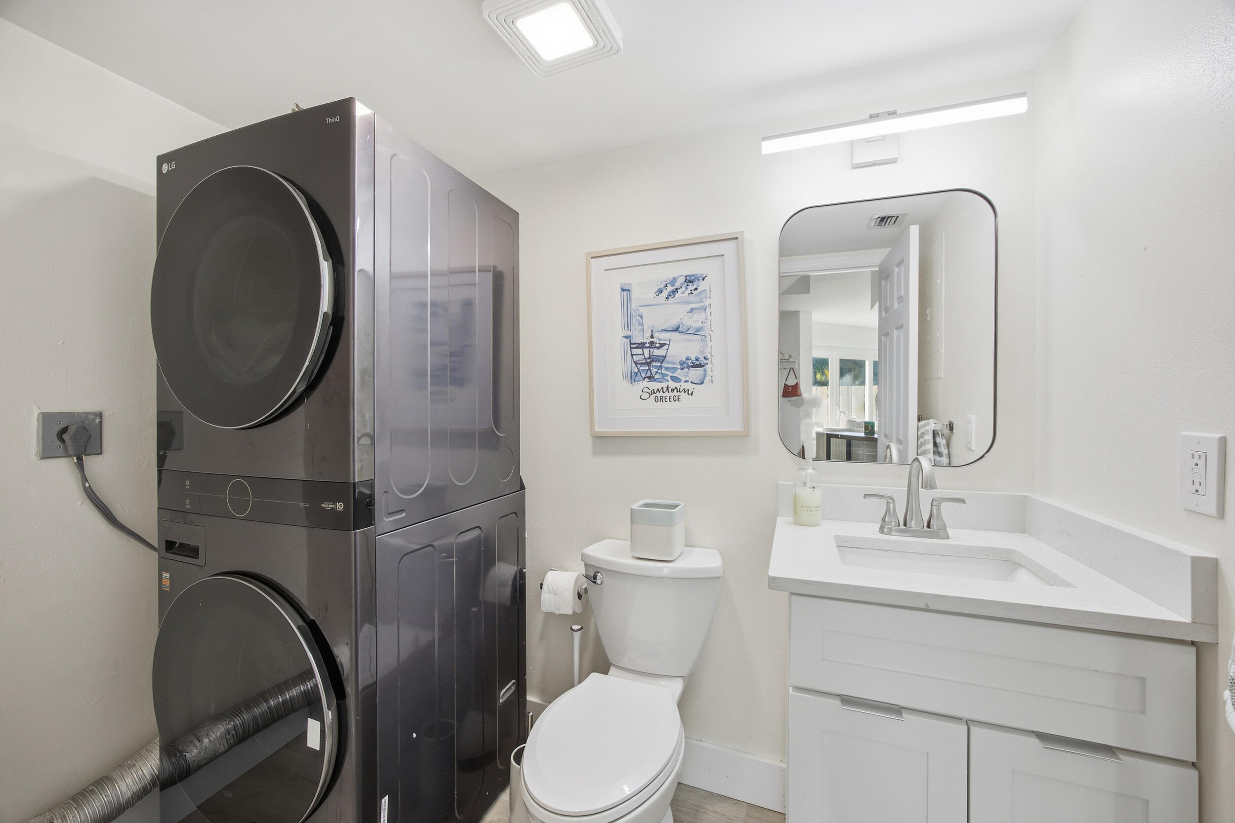 153 Seabreeze Circle Jupiter, FL 33477 - Photo 16 of 36 a bathroom with a toilet mirror and a sink