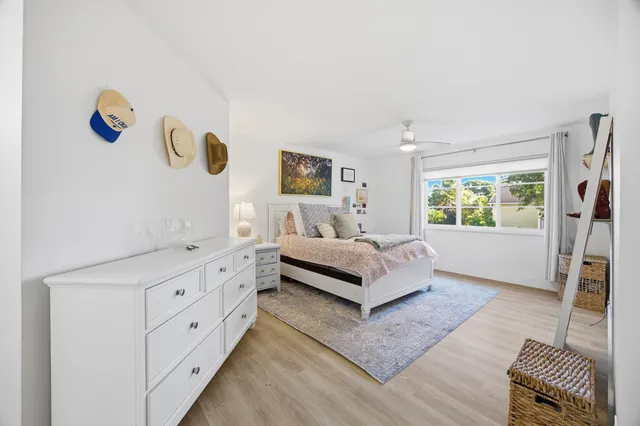 a spacious bedroom with a bed and a window