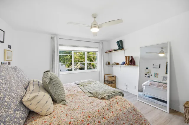 a bedroom with a large bed and a window