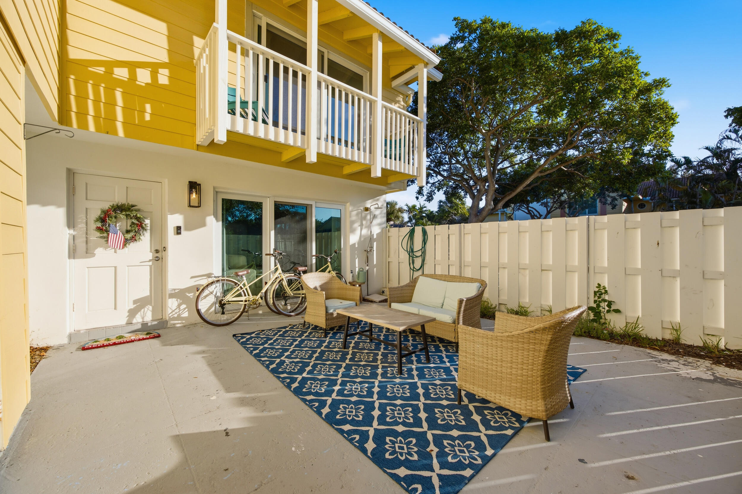 153 Seabreeze Circle Jupiter, FL 33477 - Photo 4 of 36 a view of a patio with couches table and chairs and potted plants