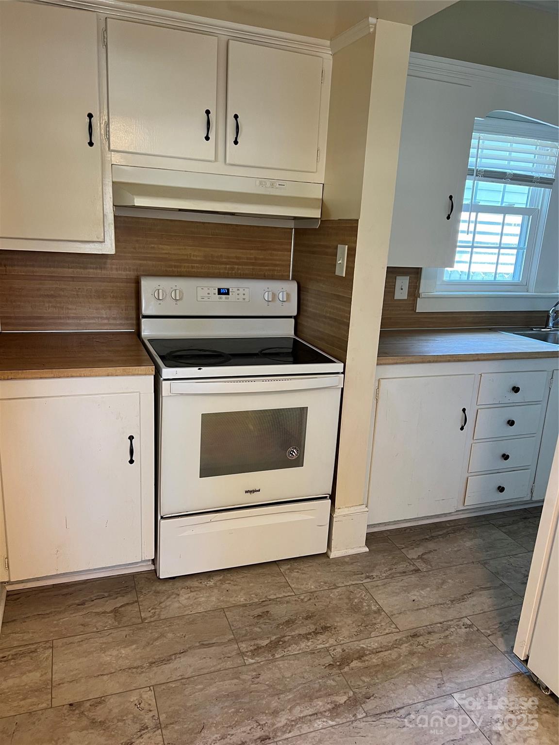 201 Goldston Street Kannapolis, NC 28081 - Photo 4 of 12 a stove top oven sitting inside of a kitchen