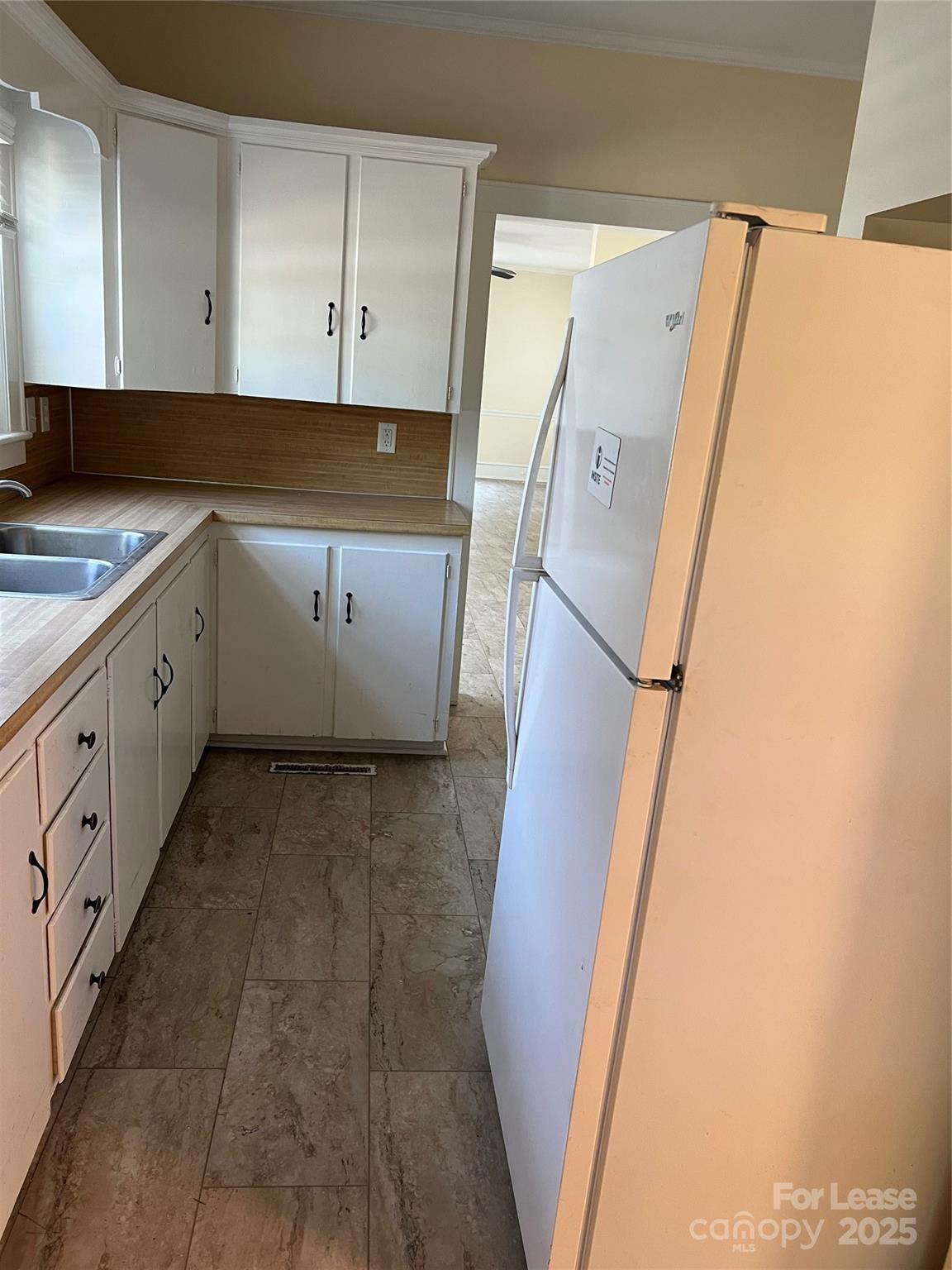 201 Goldston Street Kannapolis, NC 28081 - Photo 5 of 12 a kitchen with a refrigerator and a sink