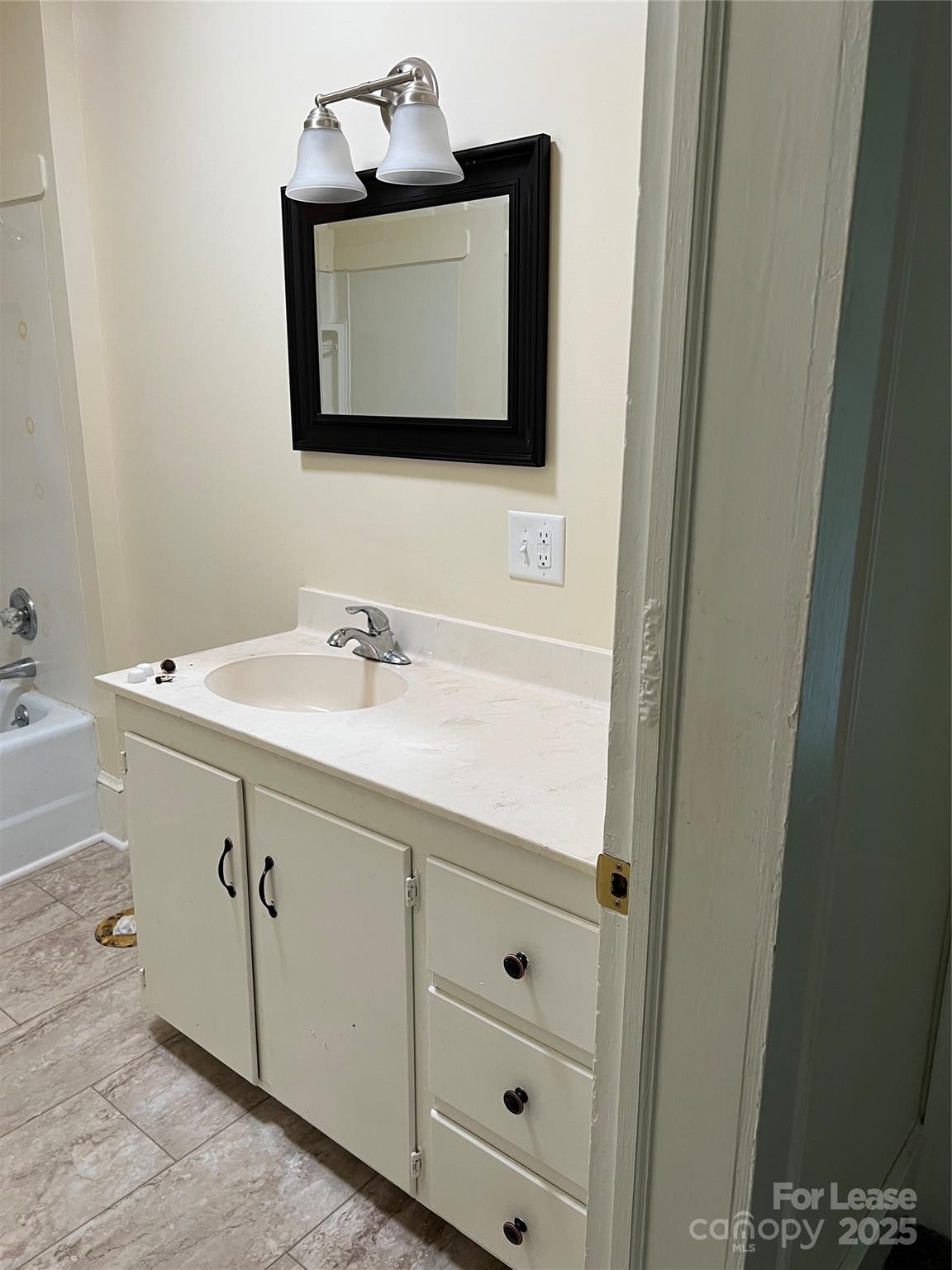 201 Goldston Street Kannapolis, NC 28081 - Photo 9 of 12 a bathroom with a sink vanity and a mirror