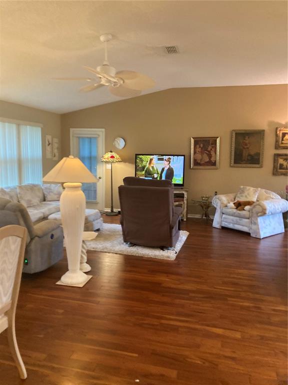 8744 Southwest 108th Ln Road Ocala, FL 34481 - Photo 3 of 28 a living room with furniture and a wooden floor