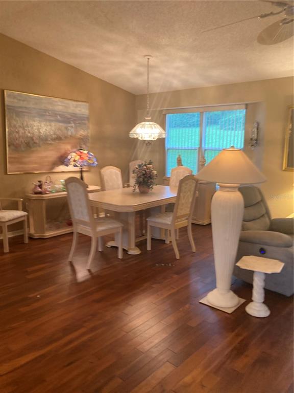 8744 Southwest 108th Ln Road Ocala, FL 34481 - Photo 4 of 28 a dining room with furniture a chandelier and wooden floor