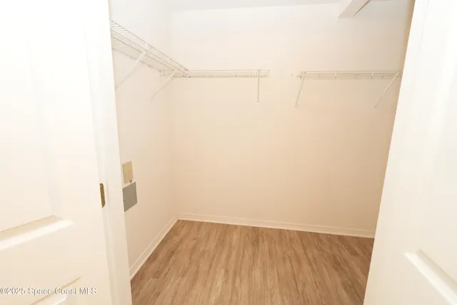 a view of a room with wooden floor